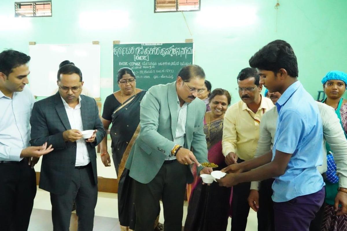 KMERC Managing Director Sanjay S. Bijjur inspecting the KMERC’s sprouted pulses distribution programme for children at a Government High School in Donimalai, Sandur taluk of Ballari district, on Tuesday.