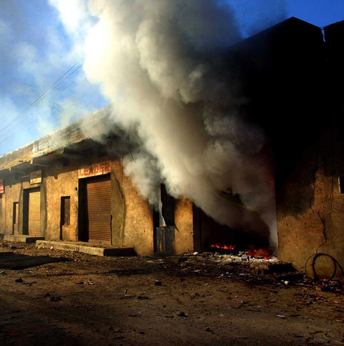 Buildings on fire during the Hindu-Muslim riots in Gujarat in 2002.