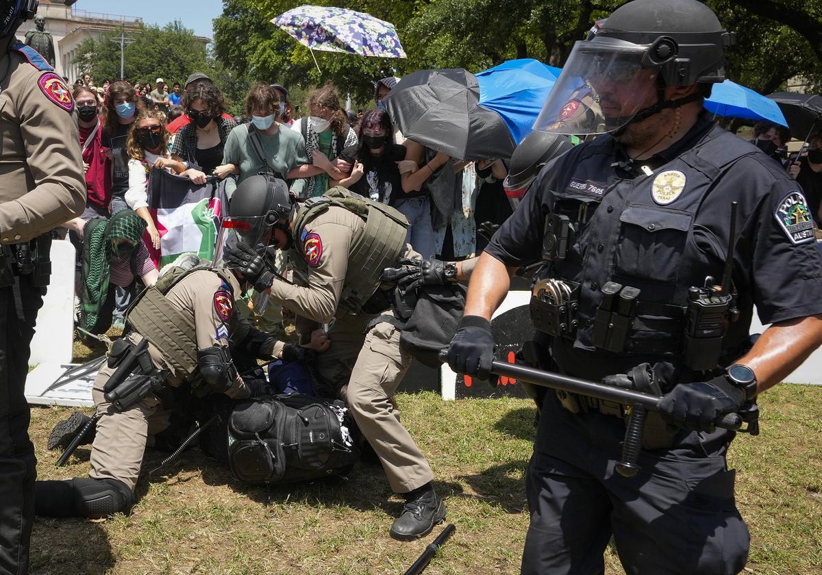 State troopers arrest a pro-Palestinian protester at the University of Texas in Austin, Texas, Monday, April 29, 2024.