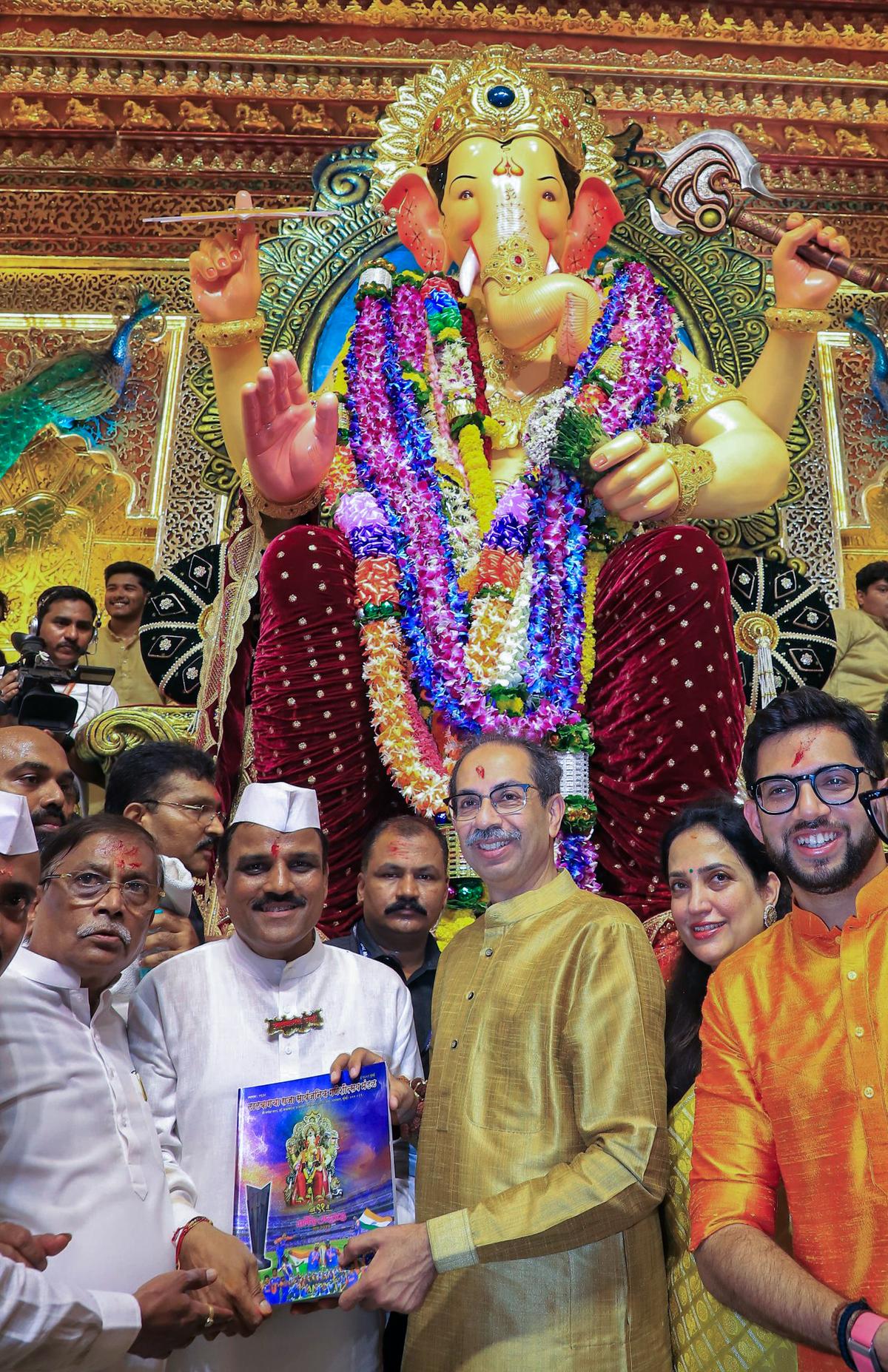 Shiv Sena (Uddhav Balasaheb Thackeray) Chief Uddhav Thackeray being felicitated at the Lalbaugcha Raja during his visit on the occasion of the Ganesh Chaturthi festival, in Mumbai on September 7, 2024. His wife Rashmi Thackeray and his son and party leader Aditya Thackeray also seen. (ANI Photo)