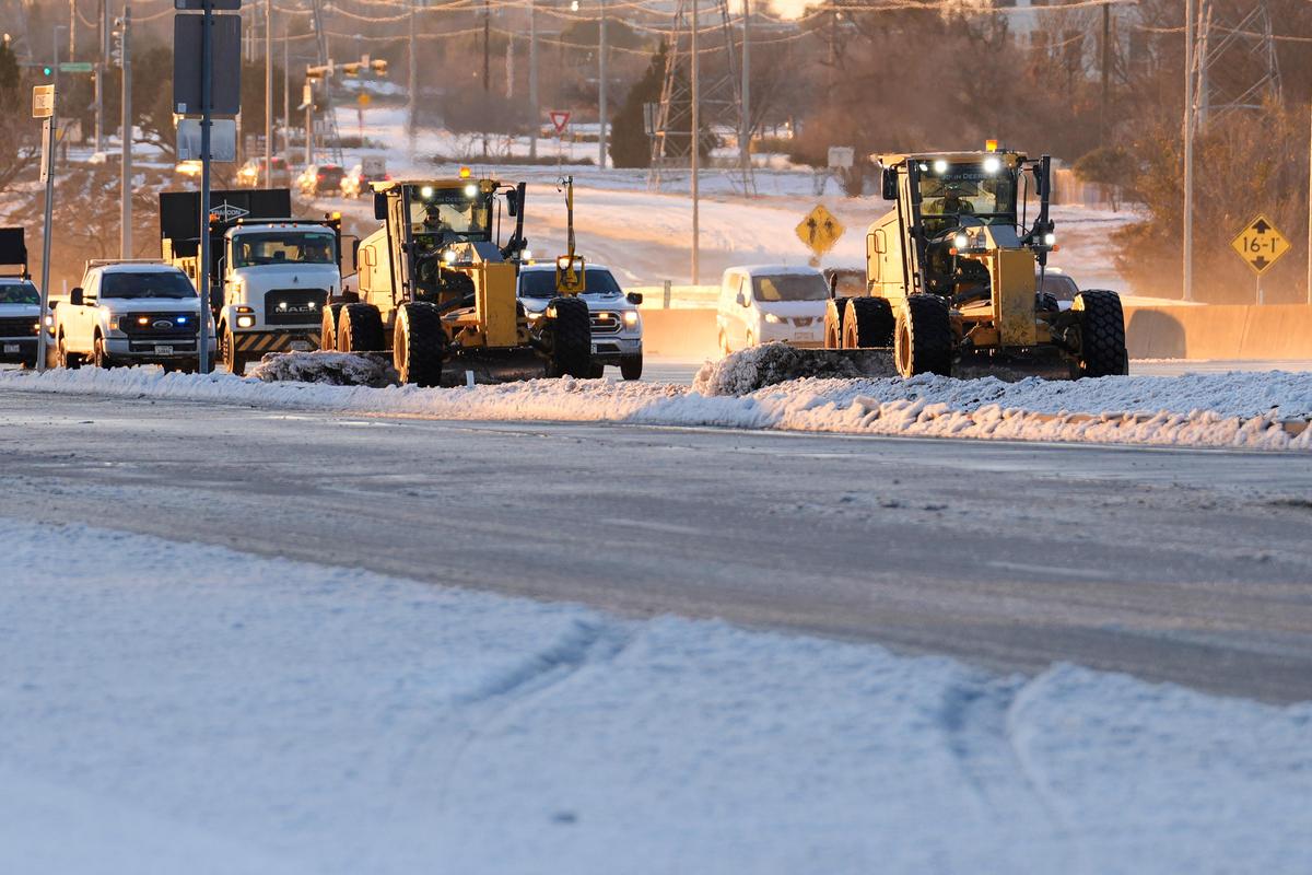 Work crews use ploughs to push snow and ice off the road on President George Bush turnpike in Plano, Texas on January 26, 2026 Work crews use ploughs to push snow and ice off the road on President George Bush turnpike in Plano, Texas on January 26, 2026