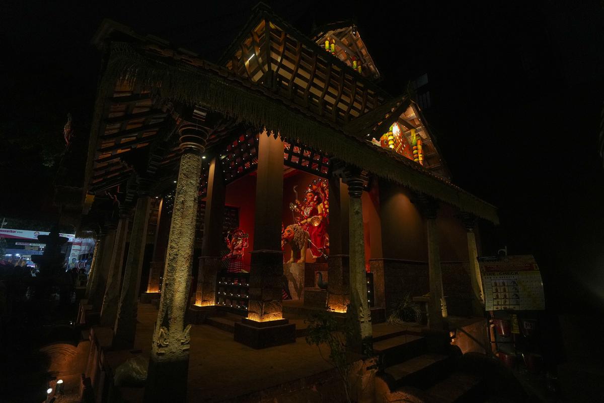 An idol of Durga at a pandal themed as Theyyam, a scared dance and worship ritual from north Kerala