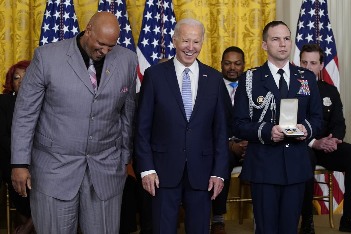 President Joe Biden laughs with U.S. Capitol Police Sgt. Harry Dunn before awarding Dunn the Presidential Citizens Medal, the nation’s second-highest civilian honor, during a ceremony to mark the second anniversary of the Jan. 6 assault on the Capitol in the East Room of the White House in Washington, on January 6, 2023. 