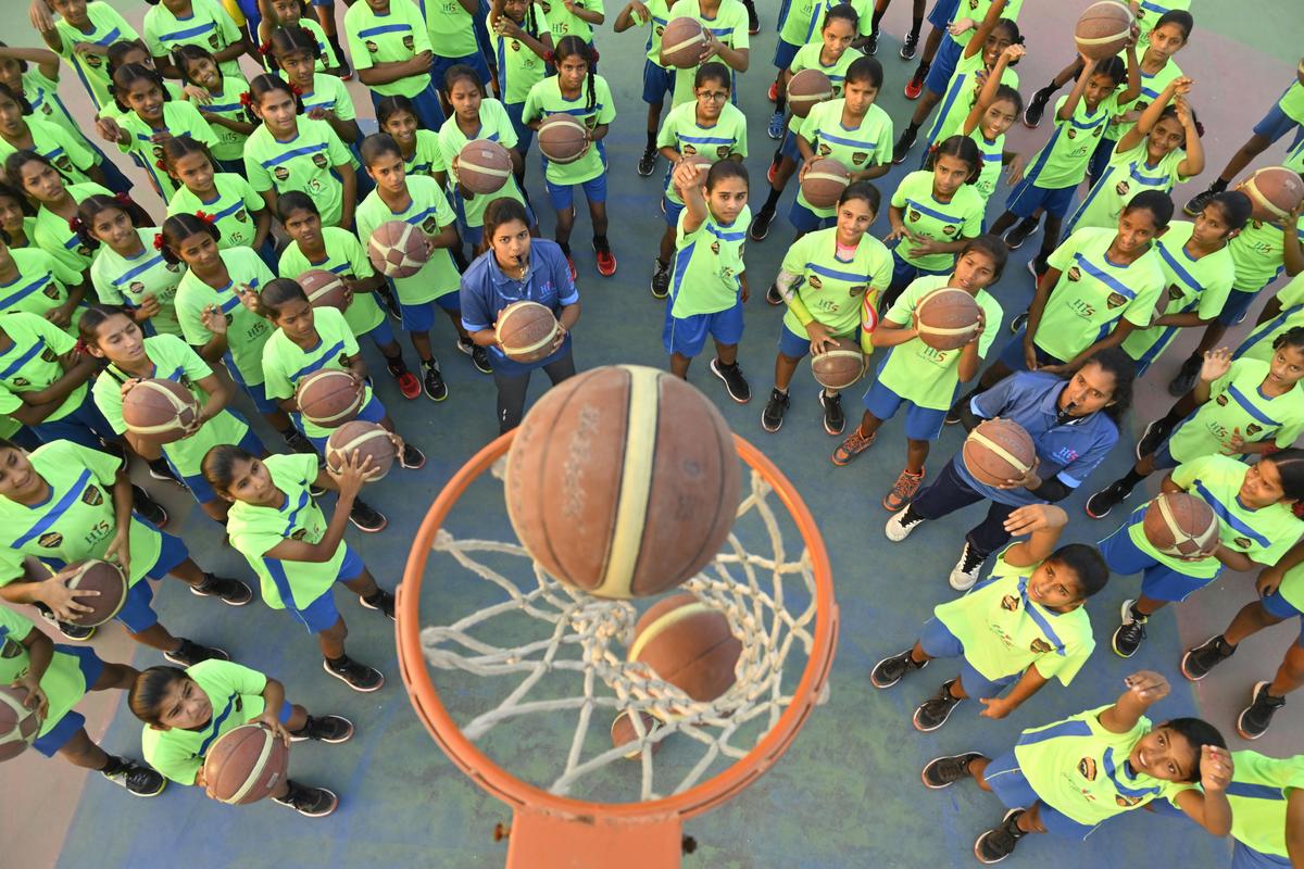 Students of Telangana Tribal Welfare Residential Educational Institutions Society Girls’ Sports School in Chegunta taking part in basketball coaching on campus.