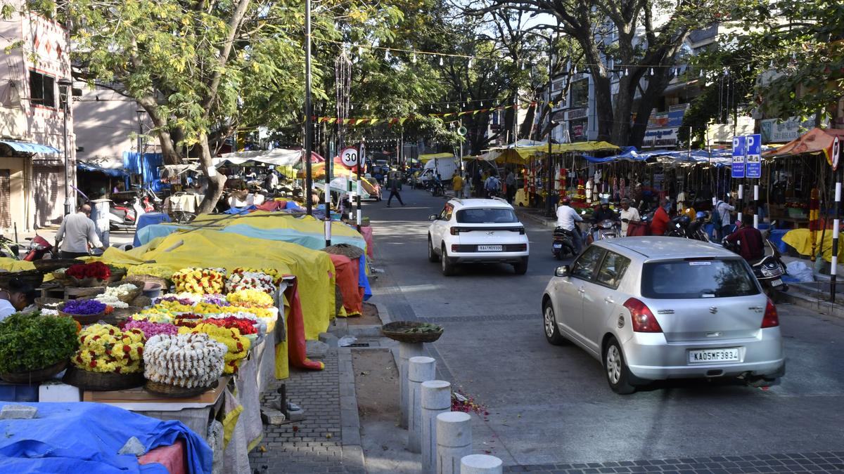 Vehicles adding to traffic chaos on narrow Gandhi Bazaar Main Road in Bengaluru due to delay in work on Multi Level Car Parking
