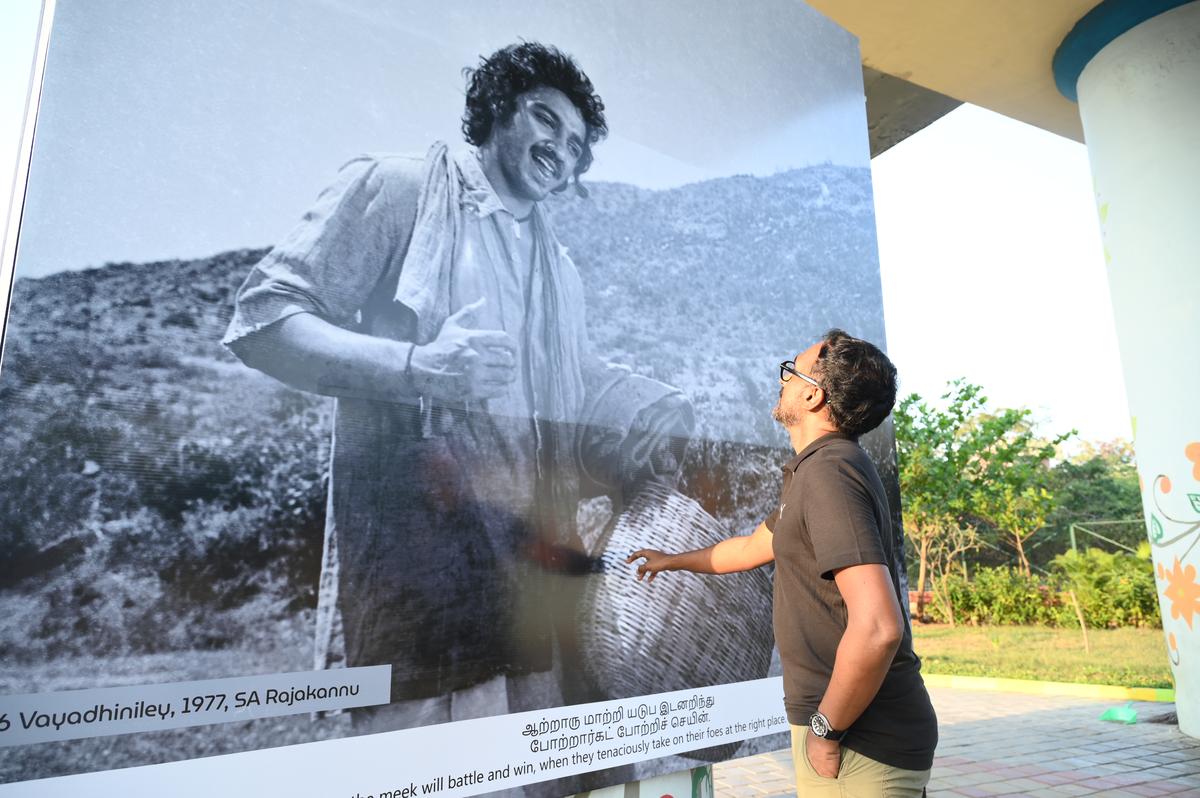 A visitor looking at a still from the movie ‘16 Vayadhinile’