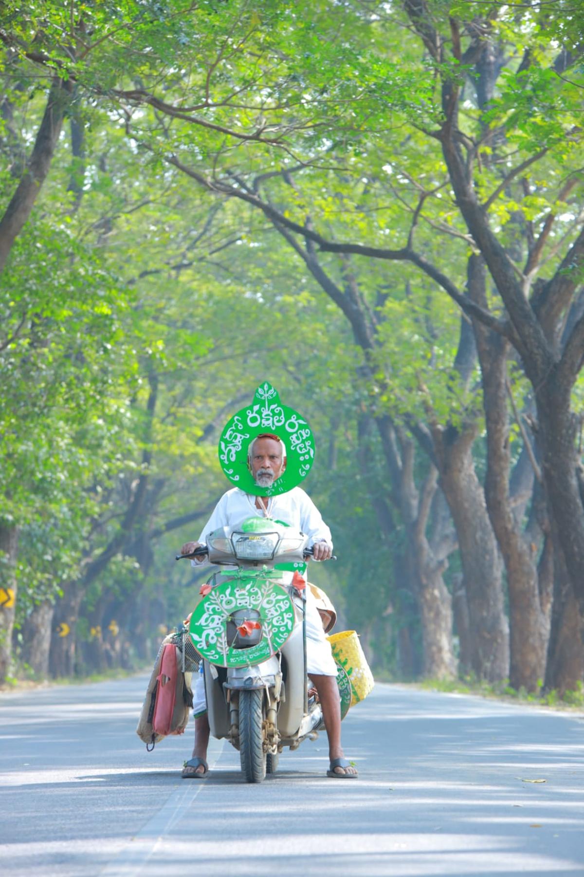 Vanajeevi Daripalli Ramaiah with the trees he planted in the background.