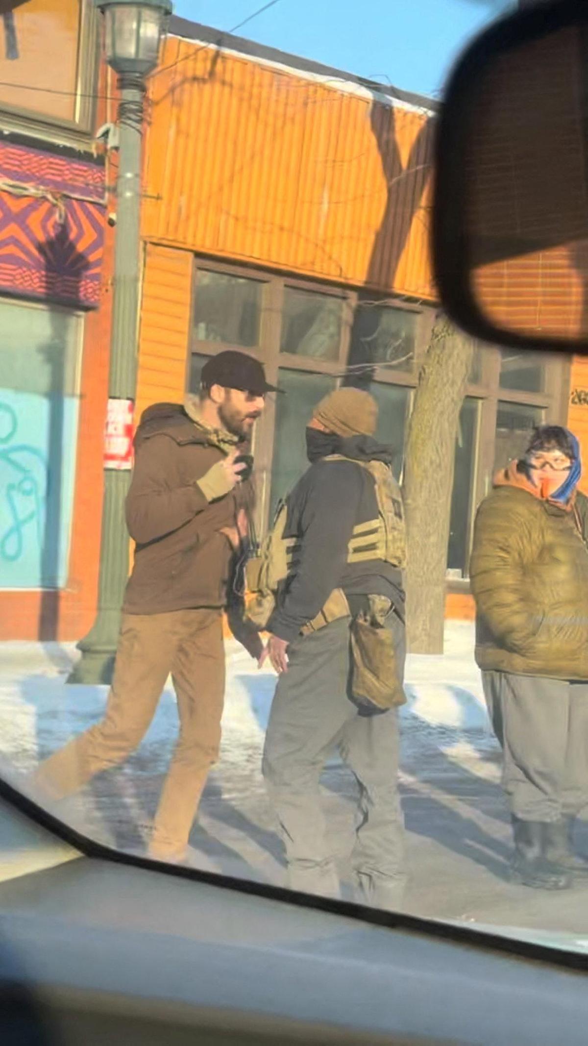 A screengrab from a video obtained by Reuters shows a man identified as Alex Pretti walking backwards on the street while holding a mobile phone near a law enforcement officer, moments before he was fatally shot when federal agents were trying to detain him, as seen through the windshield of a vehicle, in Minneapolis, Minnesota, U.S. on January 24, 2026. 
