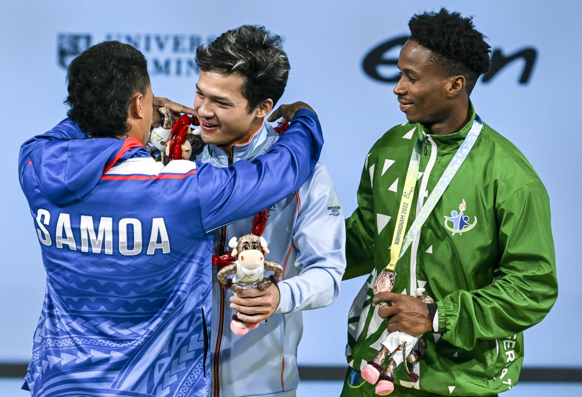 Gold medallist India’s Jeremy Lalrinnunga is garlanded by silver medallist Samoa’s Vaipava Nevo Ioane, left, as bronze medallist Nigeria’s Umoafia Edidiong looks on, during the presentation ceremony of the men’s 67kg category weightlifting event, at the Commonwealth Games 2022 in Birmingham on July 31, 2022.