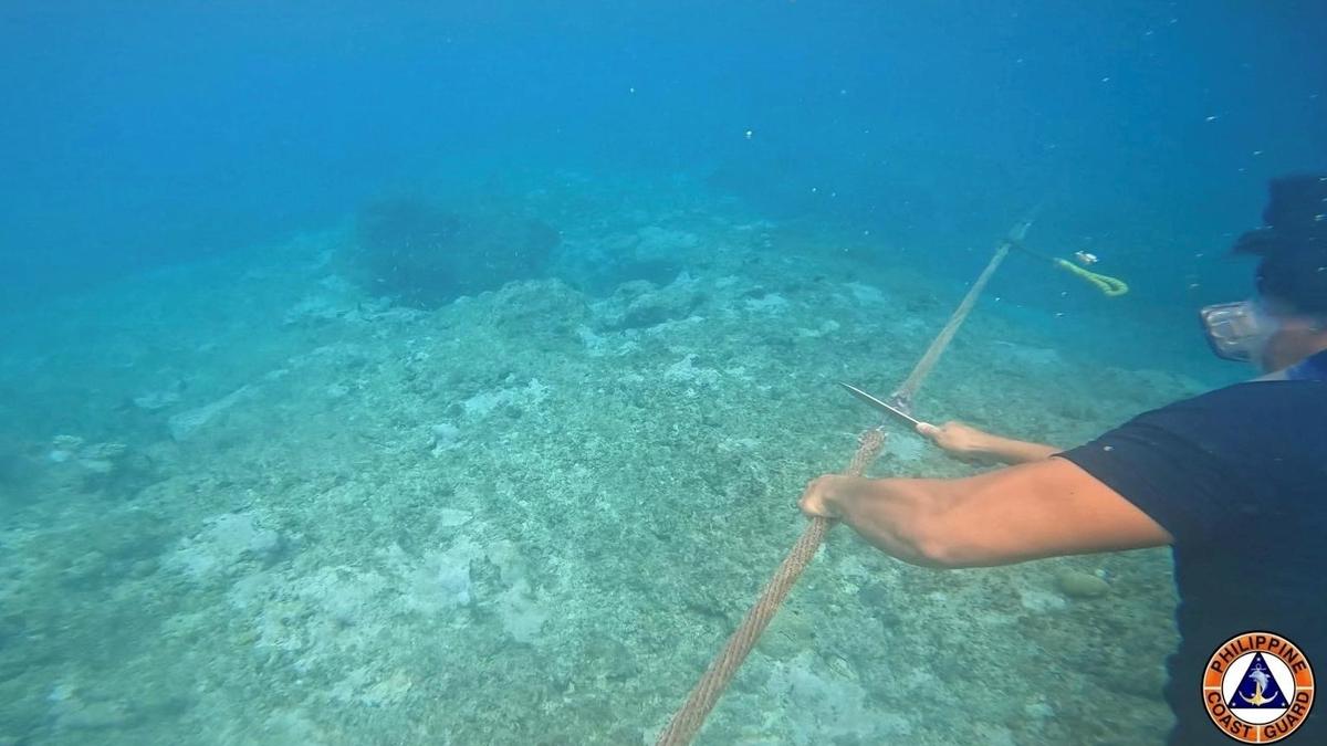 Philippines vows to remove floating barrier placed by China's coast guard at a disputed lagoon