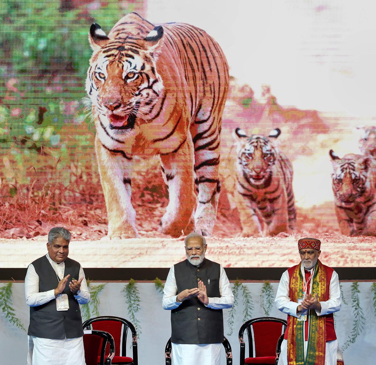 Prime Minister Narendra Modi with Union Environment Minister Bhupender Yadav and MoD Ashwini Choube at the inaugural session of commemoration of 50 years of Project Tiger, in Mysuru on April 9, 2023.