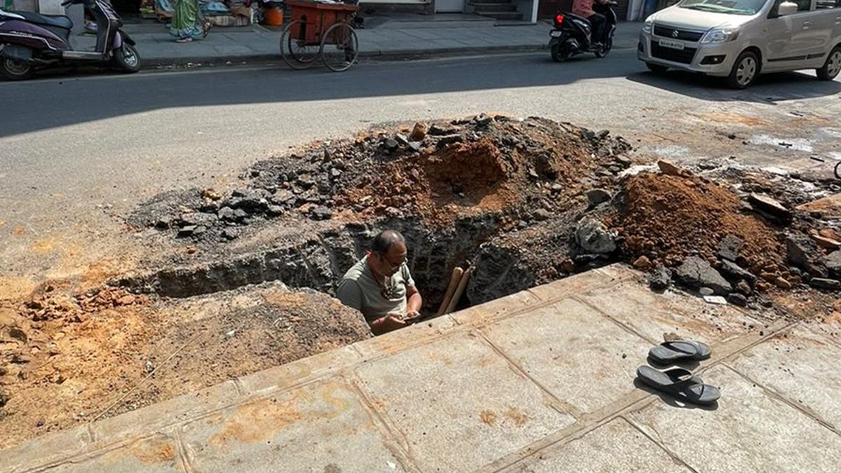 50-year-old man sits in pit demanding action against illegal digging of road in Bengaluru