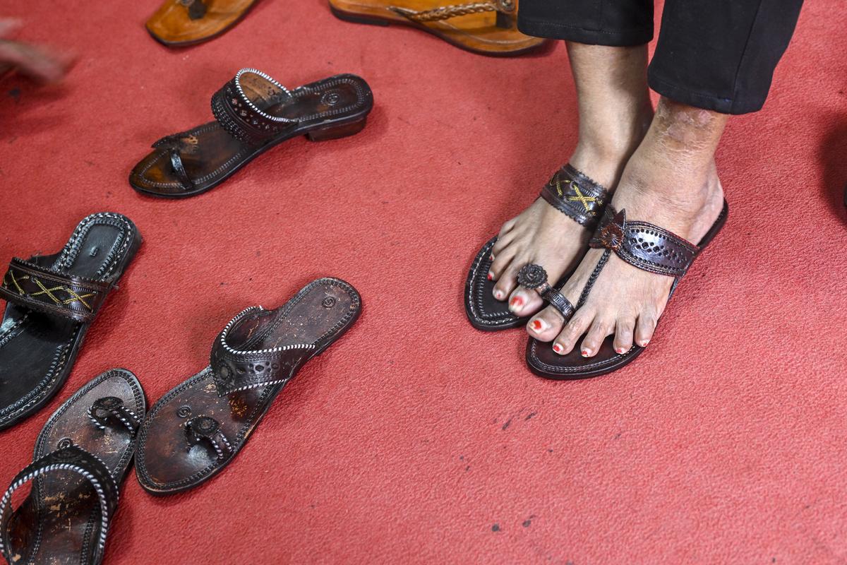Visitors shop Kolhapuri chappals  inside a store in Chappal market in Kolhapur