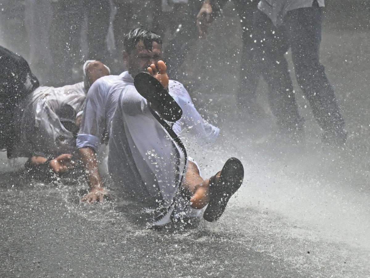 Police use water canon against Youth Congress workers when they staged a march to the district Medical Office demanding the resignation of Health Minister Veena George following the building collapse at the Government Medical College, Kottayam. 