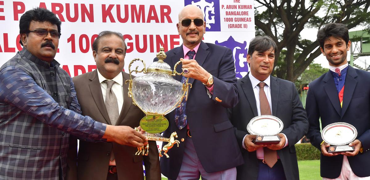 P. Arun Kumar and BTC chairman Arvind Raghavan presenting the P. Arun Kumar Bangalore 1000 Guineas trophy to  Jamari’s co-owner Rama Seshu Eyunni as trainer Pesi Shroff and jockey P. Trevor look on.