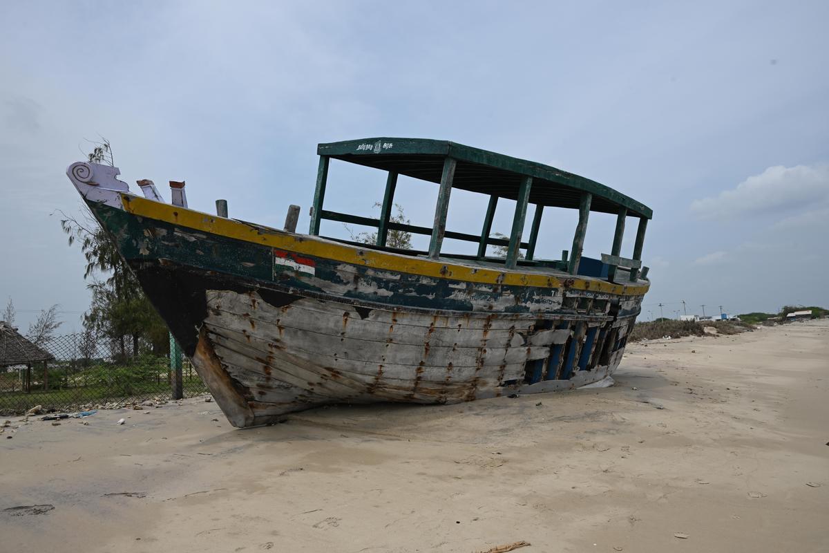 A boat once used by forest personnel lies in a dilapidated state at Tharuvaikulam beach. 