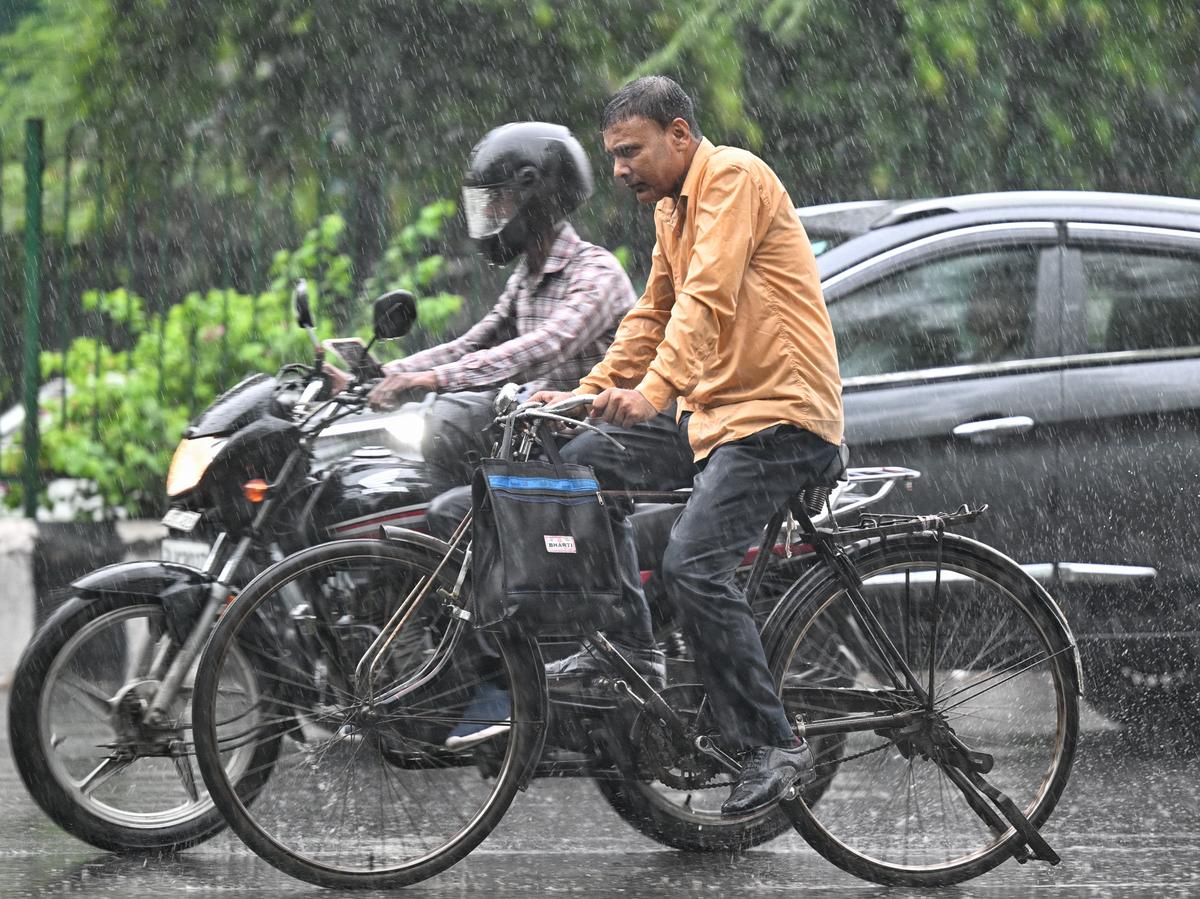 People commute as it rains in New Delhi on July 23, 2025. People commute as it rains in New Delhi on July 23, 2025.