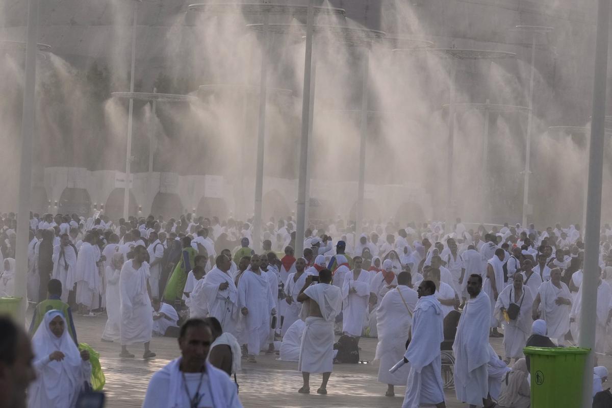 Water is sprayed on Muslim pilgrims at the rocky hill known as the Mountain of Mercy, on the Plain of Arafat, during the annual Hajj pilgrimage, near the holy city of Mecca, Saudi Arabi, on June 15, 2024. 