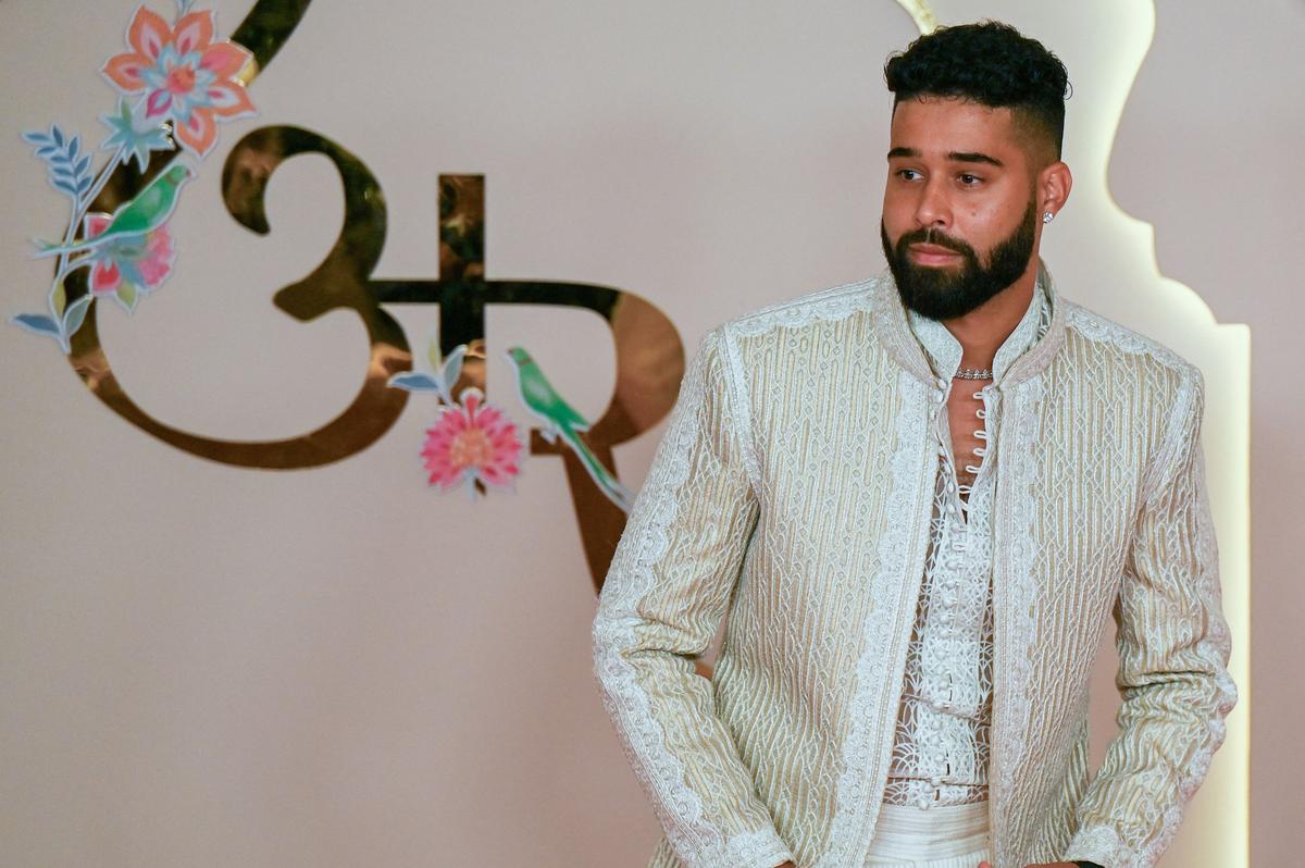 Indo-Canadian rapper Amritpal Singh Dhillon aka AP Dhillon poses for photos as he arrives to attend the wedding ceremony of billionaire tycoon and Chairman of Reliance Industries Mukesh Ambani’s son Anant Ambani and Radhika Merchant in Mumbai on July 12, 2024