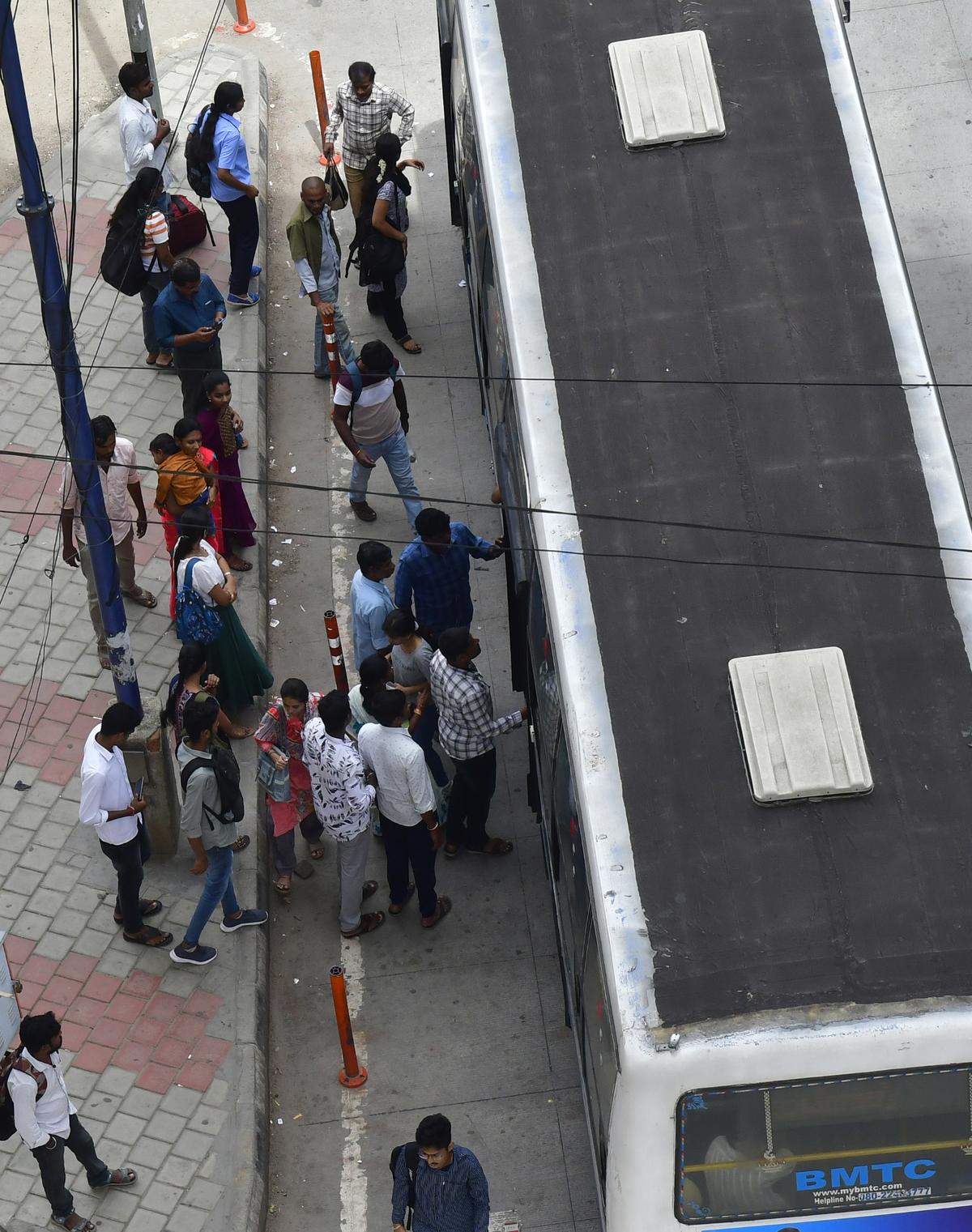 Commuters taking a BMTC bus at Nayandahalli ring road junction during the transport strike in Bengaluru on Monday.
