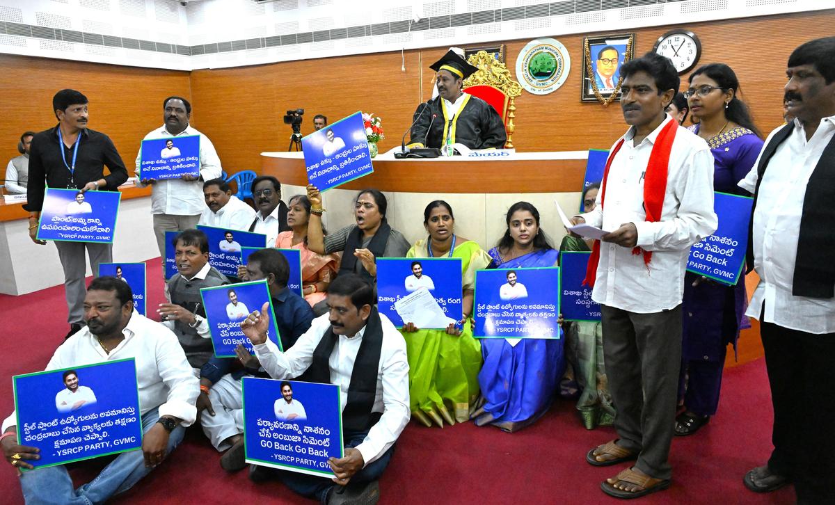 Corporators from the YSRCP and CPI(M) corporator B. Ganga Rao stage a sit-in before the Mayor’s podium over the proposed VSP privatisation and the proposal to establish a cement grinding unit at Pedagantyada, during the council meeting in Visakhapatnam on Friday.