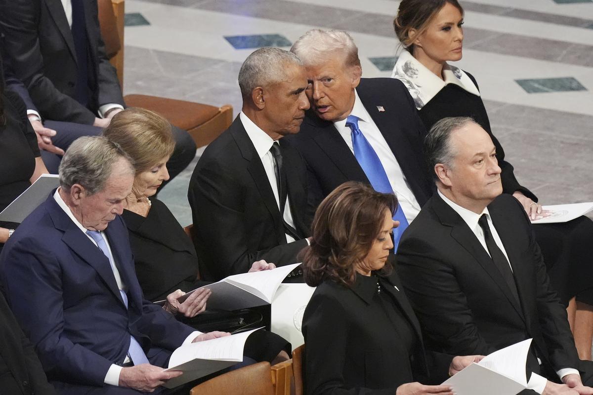 Former President Barack Obama talks with President-elect Donald Trump as Melania Trump listens and as former President Geroge W. Bush, Laura Bush, Vice President Kamala Harris, and second gentleman Doug Emhoff arrive, before the state funeral for former President Jimmy Carter