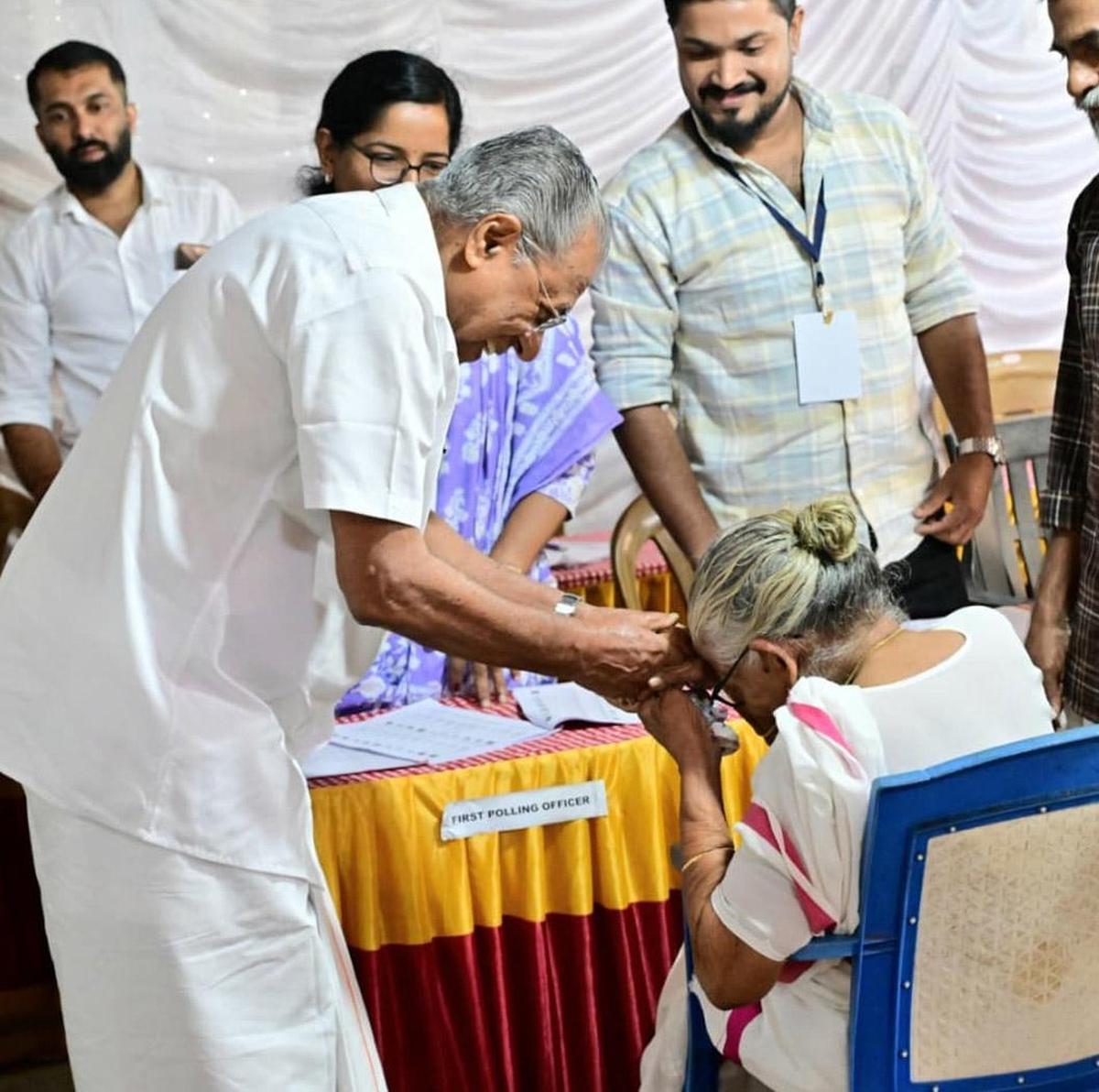 Chief Minister Pinarayi Vijayan greets a senior citizen at a poling station at the Pinarayi Panchayat Junior Basic School in Kannur on Thursday. 