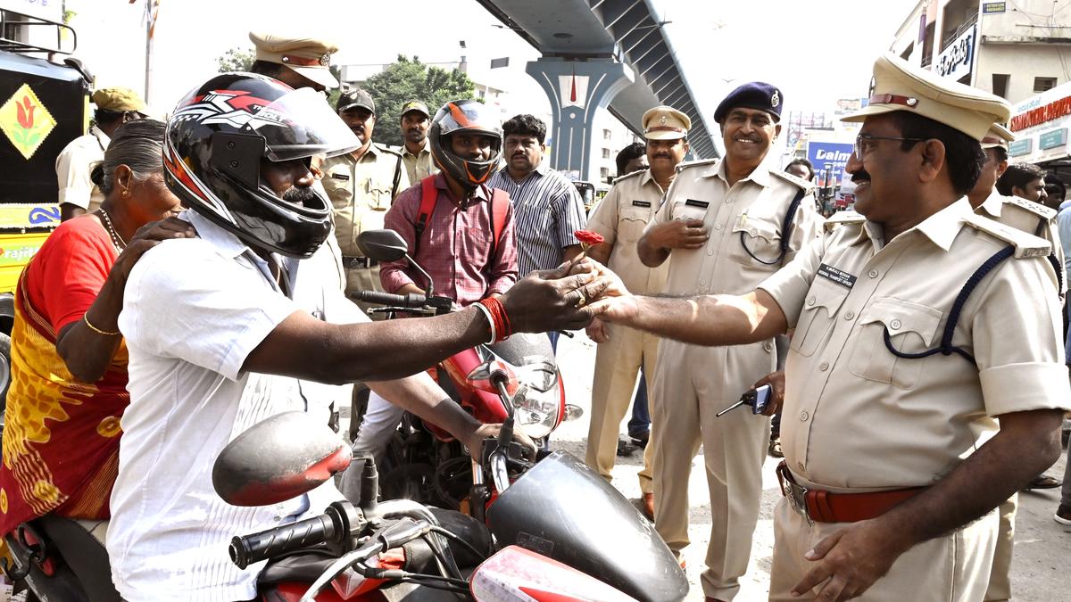 Helmet-wearing motorists offered roses in Tirupati