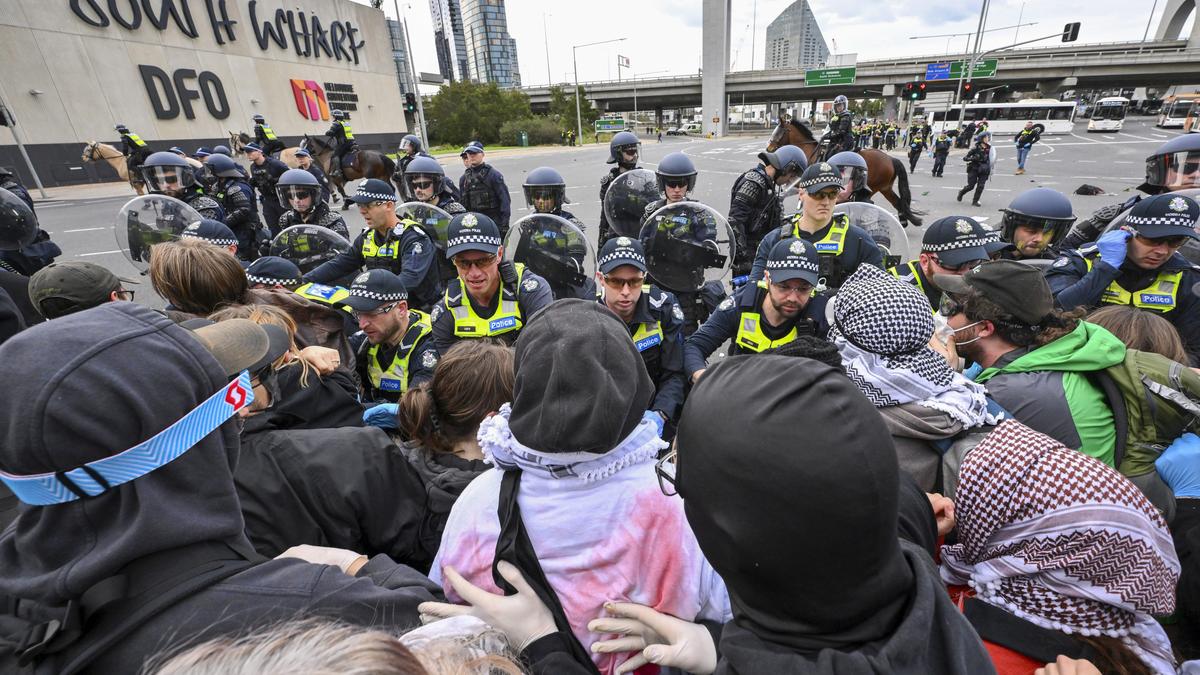 Anti-war protesters clash with police outside Australian weapons convention