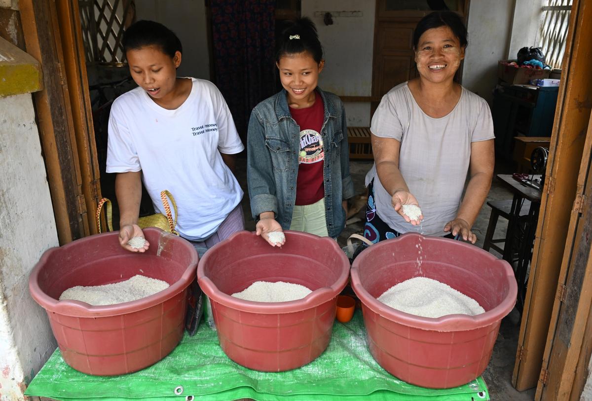 In the border town of Moreh, Manipur, many Myanmar women have found a second rhythm to life - following their children to school and trading rice. In the border town of Moreh, Manipur, many Myanmar women have found a second rhythm to life - following their children to school and trading rice.