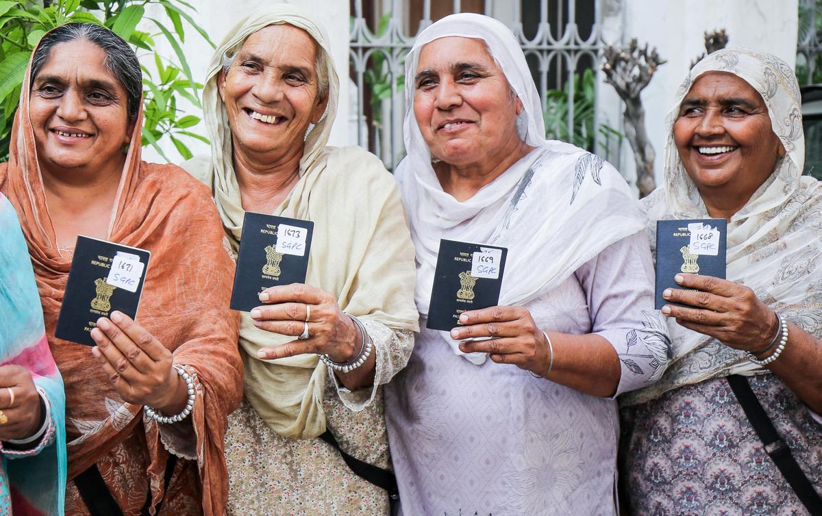 Sikh pilgrims bound for Pakistan for the 10-day pilgrimage to Guru Nanak Dev's birthplace, Nankana Sahib, with their passports after visa processing from the Shiromani Gurdwara Parbandhak Committee (SGPC) office, in Amritsar on Friday.