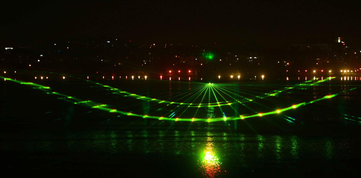 The laser show organized on Hussainsagar lake in Hyderabad to celebrate ‘Bathukamma’ festival. File