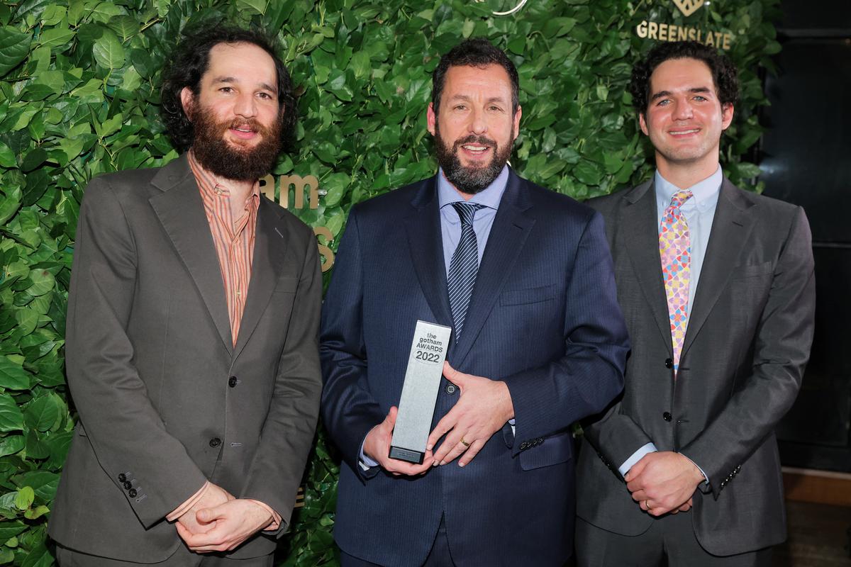 Josh Safdie and Benny Safdie pose with Adam Sandler holding a Film Tribute Award at the 2022 Gotham Awards 