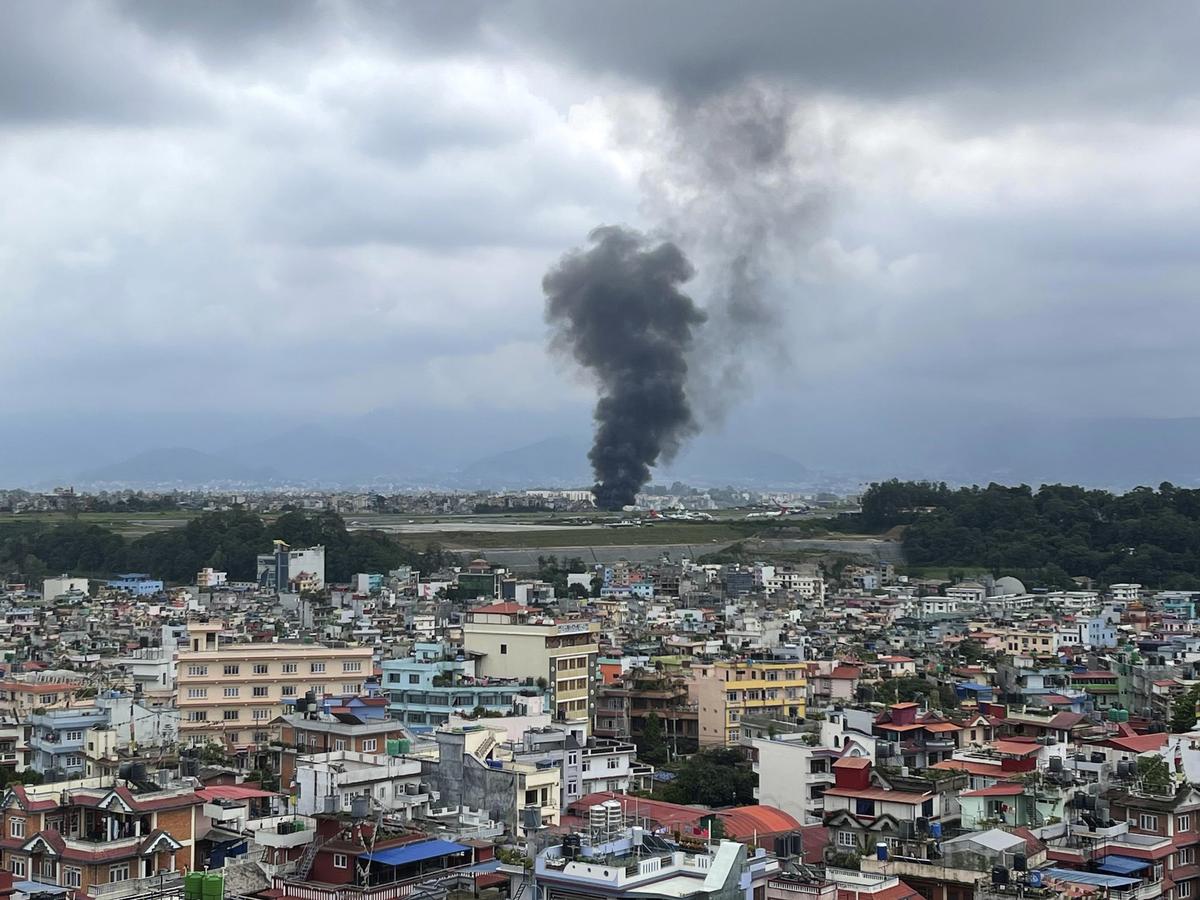 Smoke rises from the Tribhuvan International Airport in Kathmandu, Nepal, on July 24, 2024. State television in Nepal says a plane has slipped off the runway and crashed while trying to take off from Kathmandu airport