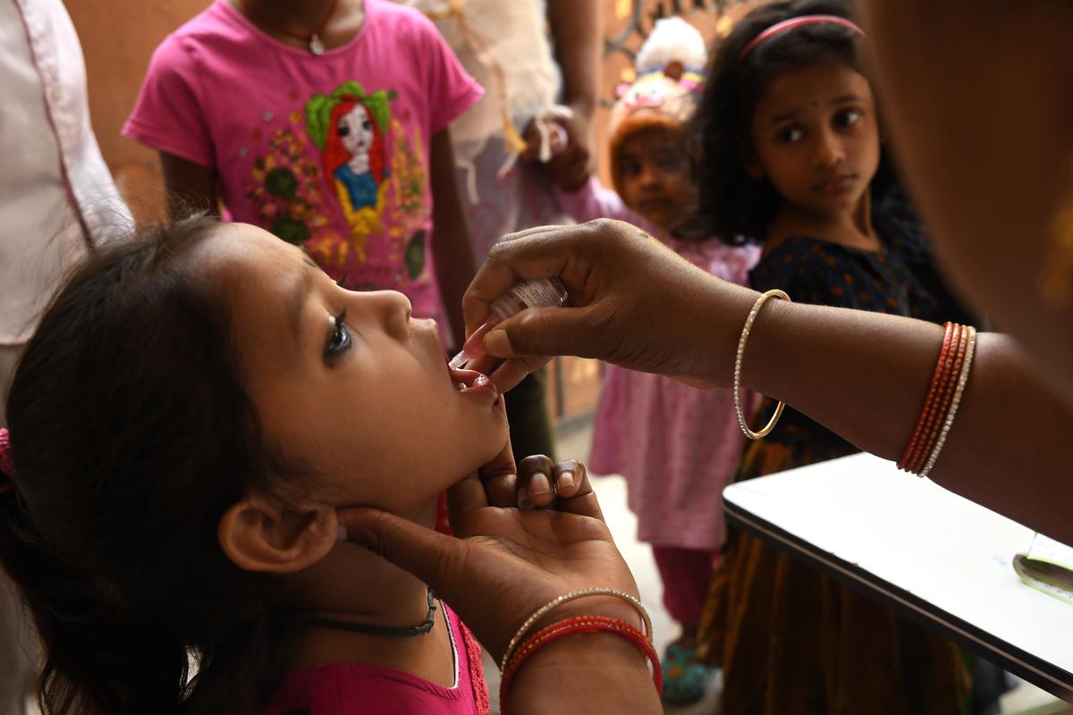 A healthcare worker administers a dose of polio drops to a child during an immunisation drive, at Begumpet in Hyderabad on March 3, 2024.