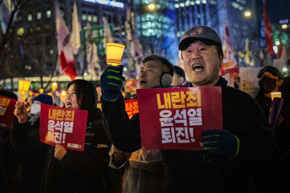 Protesters light candles as they take part in a demonstration against the South Korean President on December 5, 2024 in Seoul, South Korea.