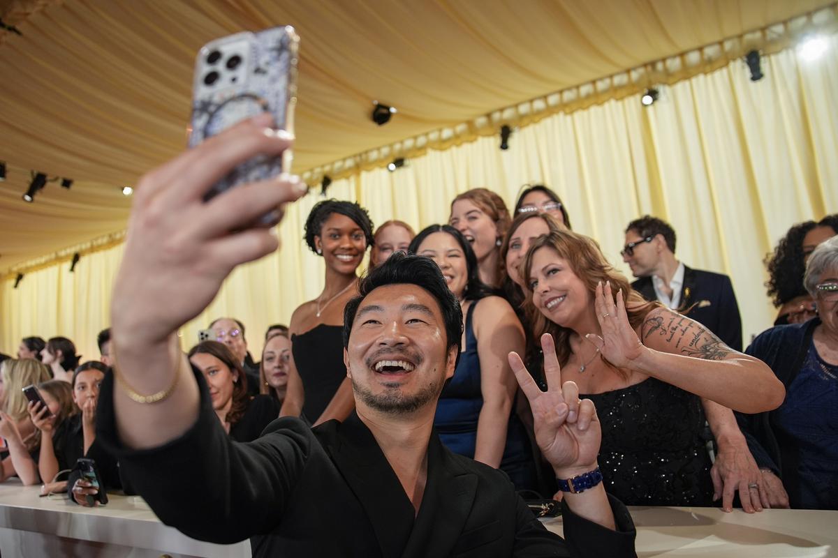 Simu Liu poses for a selfie at the Oscars on Sunday, March 10, 2024, at the Dolby Theatre in Los Angeles. (AP Photo/John Locher)