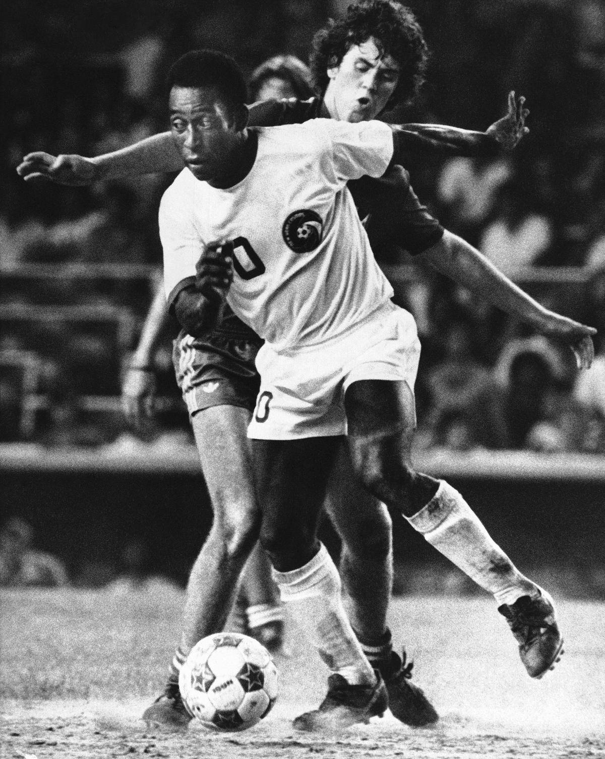 New York Cosmos forward Pelé controls the ball as Miami Toros midfielder Tommy Mulroy defends during the second half of an NASL soccer game at New York’s Yankee Stadium on Aug. 10, 1976. File.