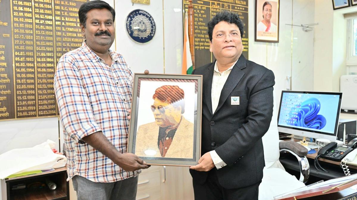 Artist presents millet portrait to Divisional Railway Manager in Visakhapatnam