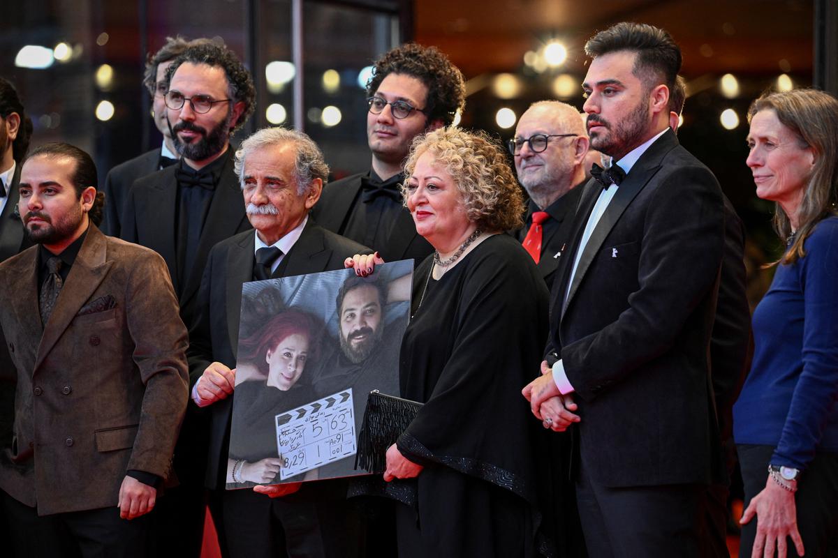 Cast members Lili Farhadpour and Esmail Mehrabi hold a picture of directors Maryam Moghaddam and Behtash Sanaeeha, on the day of the screening of the movie ‘My Favourite Cake’ (“Keyke mahboobe man”) at the 74th Berlinale International Film Festival in Berlin