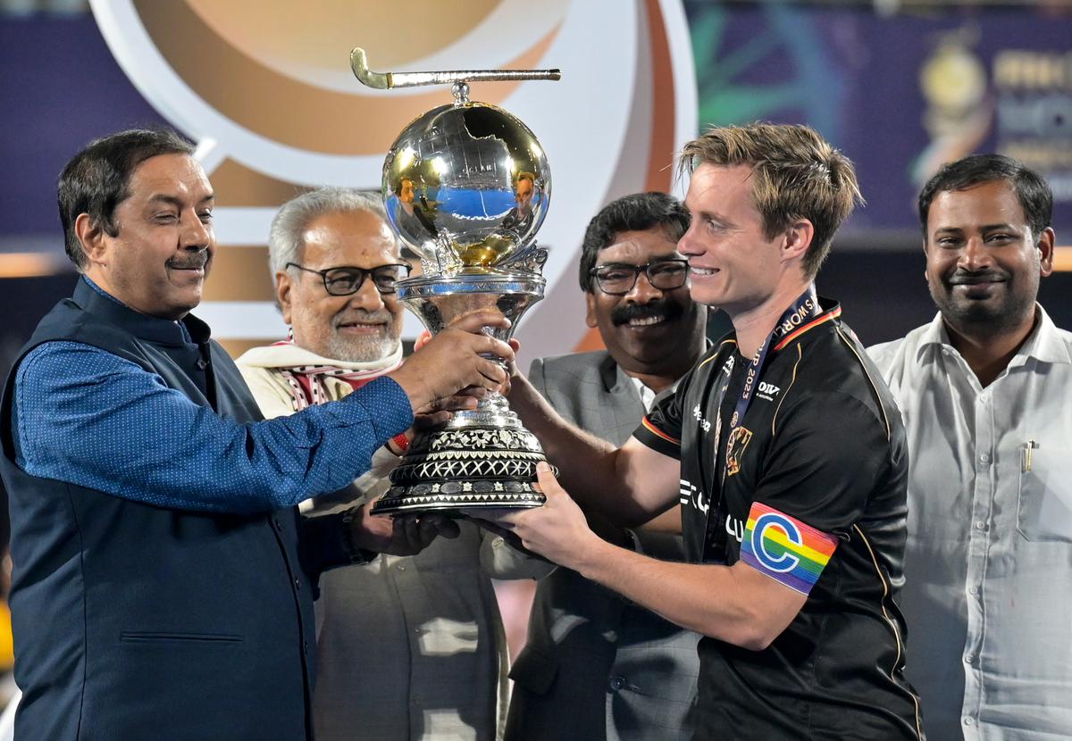 Germany’s captain Mats Grambusch receives the trophy after winning the FIH men’s hockey World Cup 2023 final against Belgium at the Kalinga Stadium in Bhubaneswar, on January 29, 2023. 
