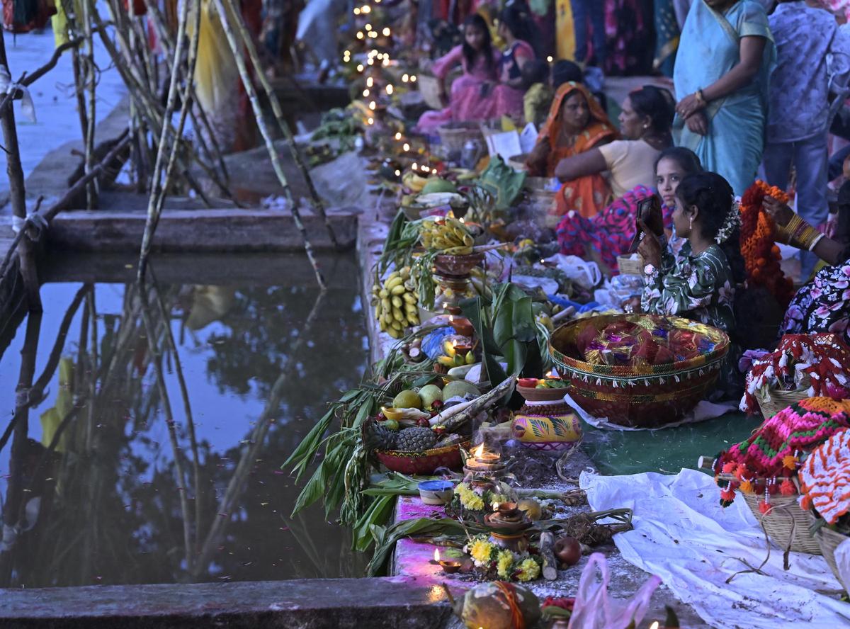 Devotees gather at Bathukamma Ghat, Tank Bund, to offer Sandhya Arghya to the setting sun during Chhath Puja celebrations in Hyderabad on Monday.