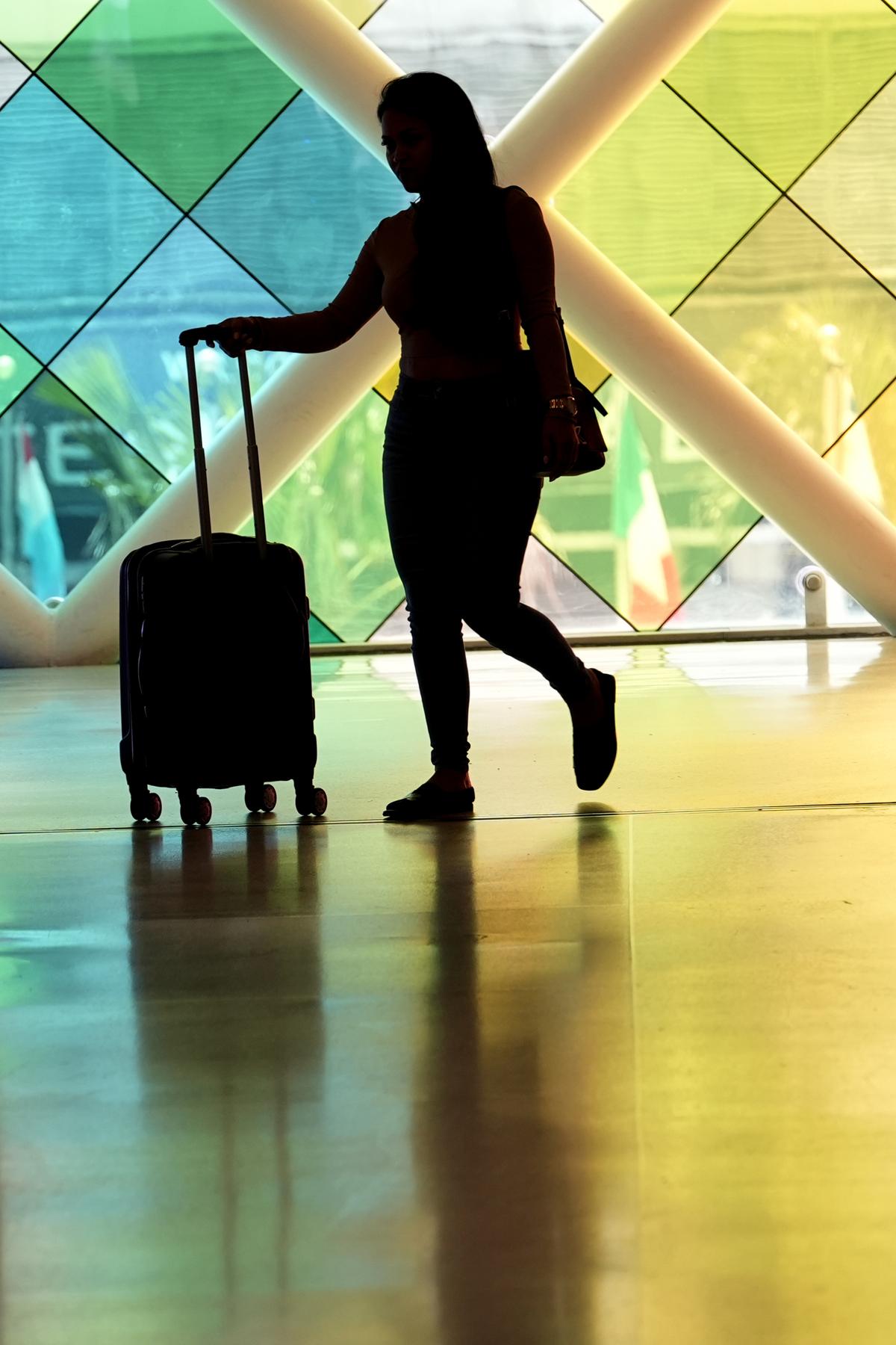 A traveler walks through Miami International Airport in Miami on July 3, 2024.  A long Fourth of July holiday weekend is expected to create new travel records.  