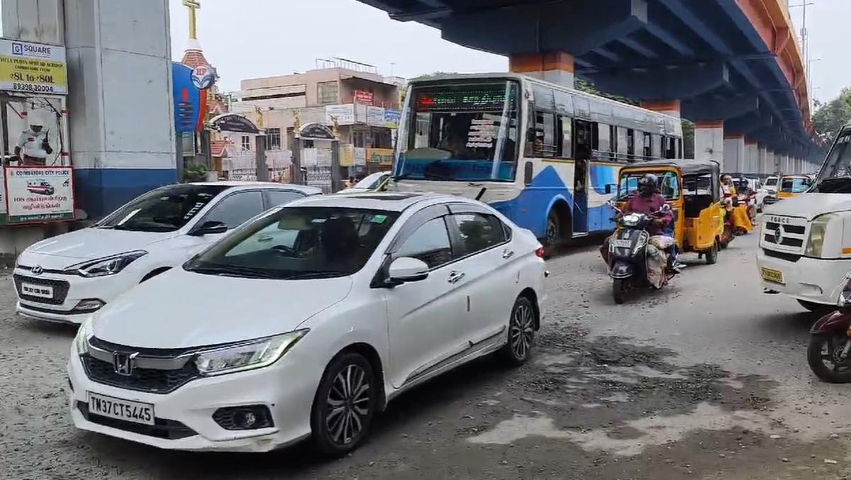 Motorists commuting through Ramanathapuram junction have to navigate potholes and blue metals scattered on the road. 