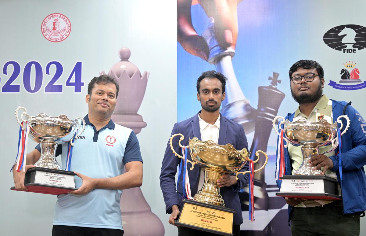 Winner Karthik with second-placed Ganguly, left, and Saha, who finished third.