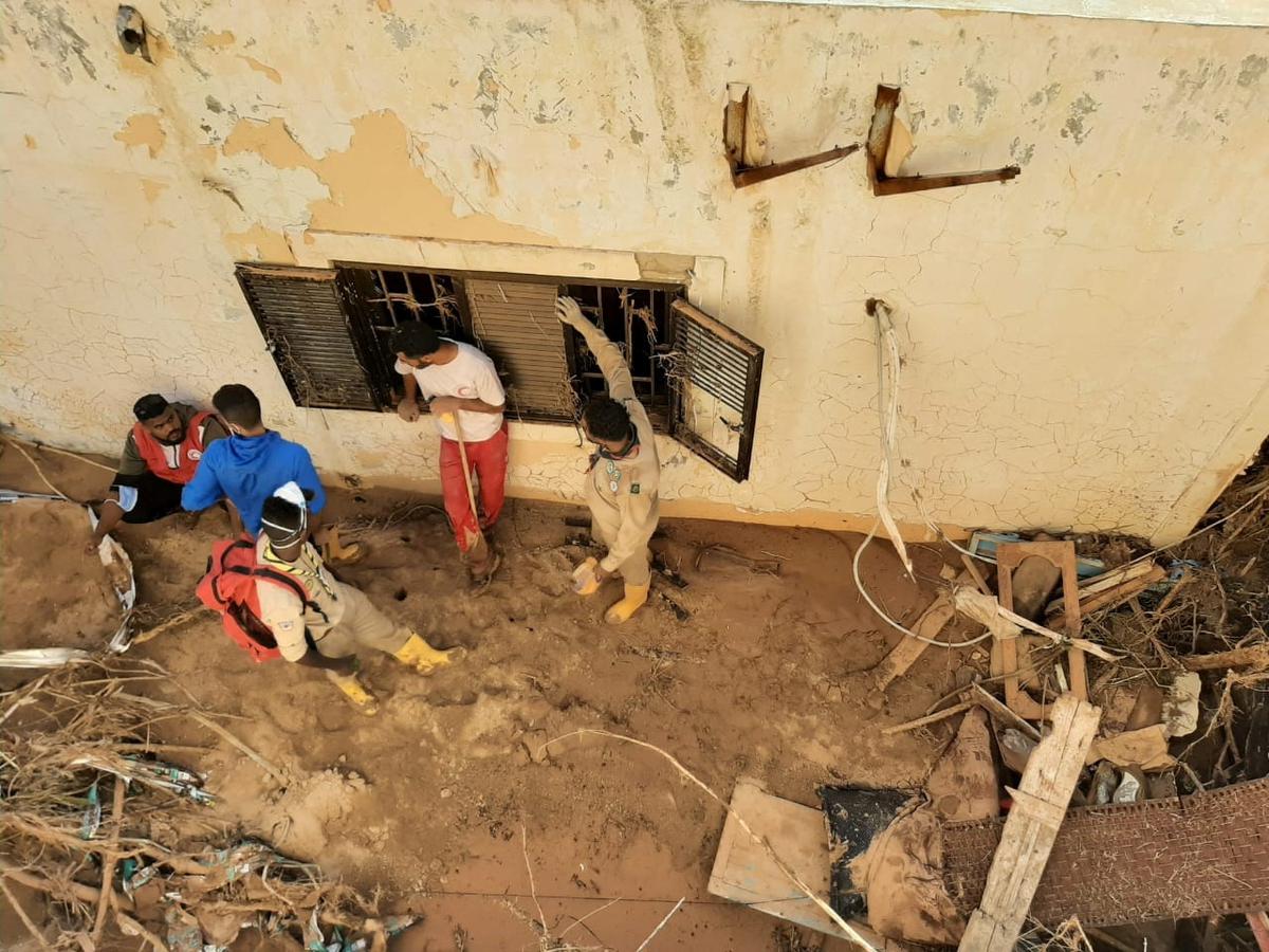 Members of Libyan Red Crescent Ajdabiya work in an area affected by flooding, in Derna, Libya.