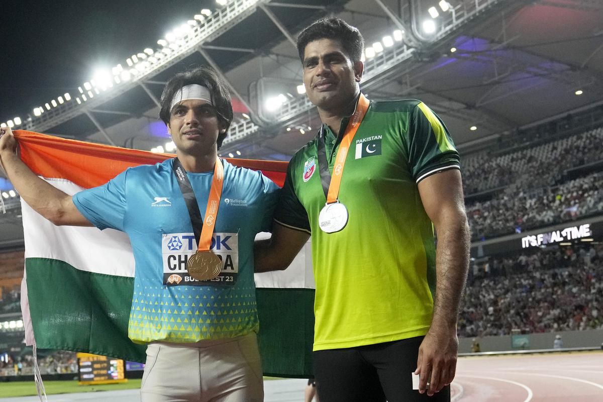 Gold medalist Neeraj Chopra, of India, and silver medalist Arshad Nadeem, of Pakistan, right, pose after finishing the Men’s javelin throw final during the World Athletics Championships in Budapest.