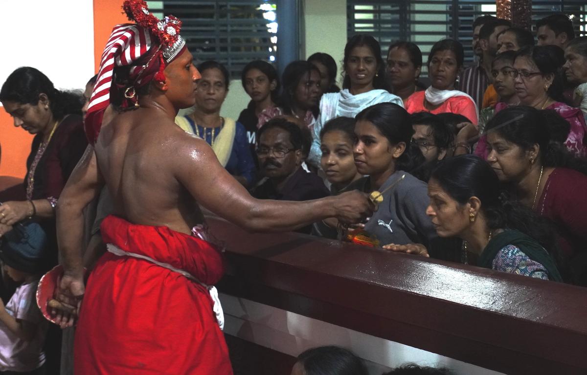 Kathivanoor Veeran Theyyam Kathivanoor Veeran Theyyam blessing a devotee after Vellattam