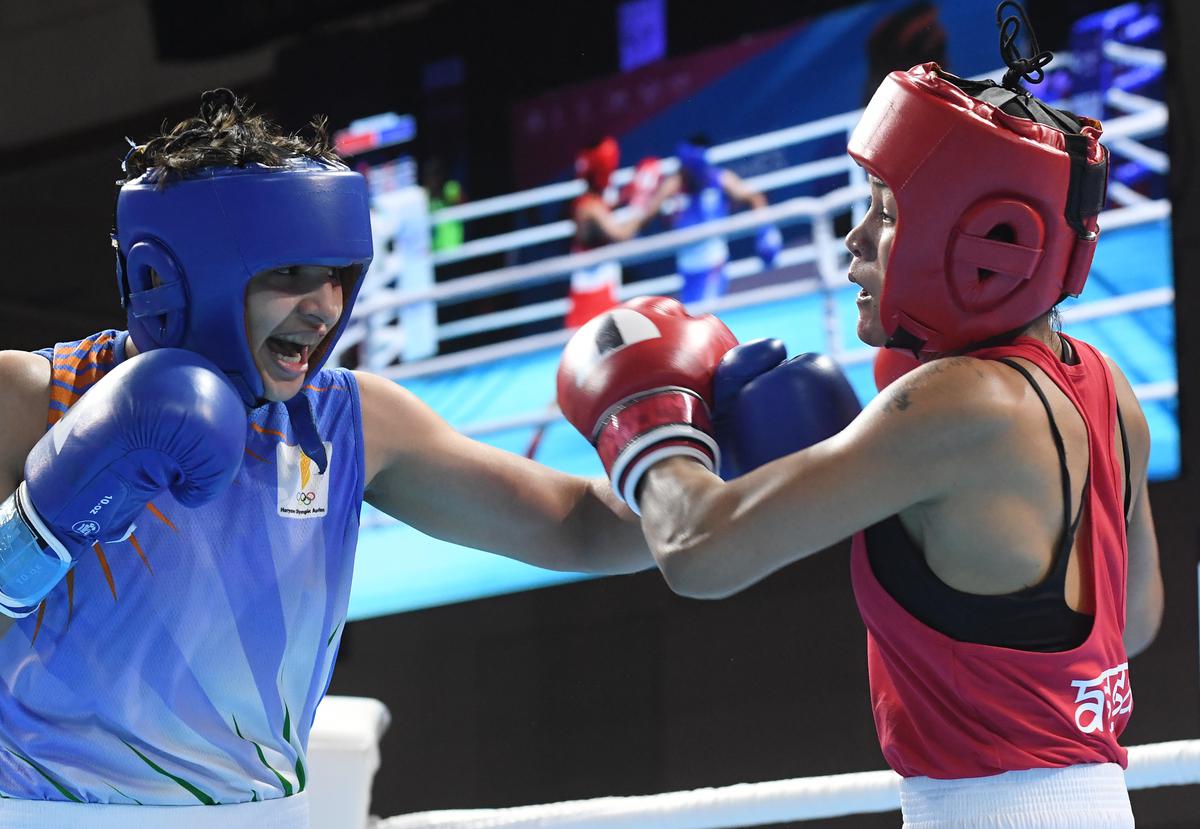Haryana’s Poonam, left, lands one on Jamuna Boro of Assam in the 57kg semifinals of the 36th National Games at Gandhinagar on Tuesday.