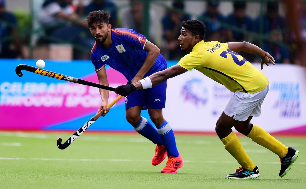 Tamil Nadu’s Mareeswaran Sakthivel (29) tries to stop Mandeep Mor of Haryana, who scored the third goal in the hockey quarterfinal at the 36th National Games in Rajkot on Saturday, 8 October 2022. 